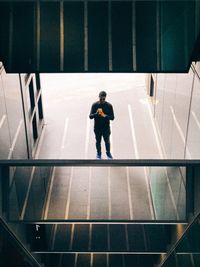 Rear view of boy walking in city
