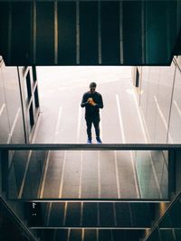 Mirror view of boy walking in city