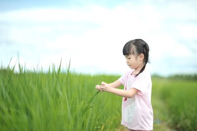 Cute girl standing in field