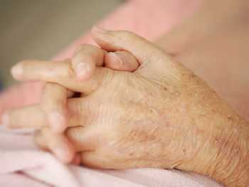 Close-up of baby hands on bed