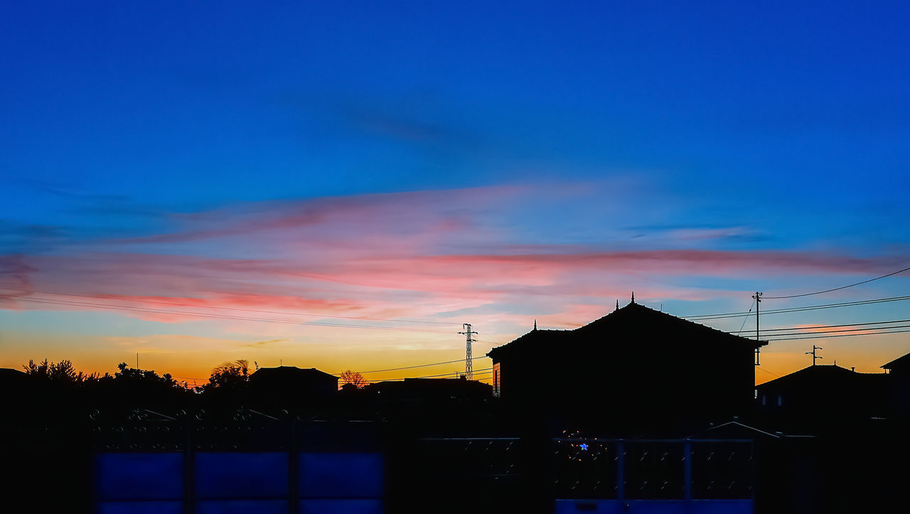 SILHOUETTE BUILDINGS AGAINST ORANGE SKY