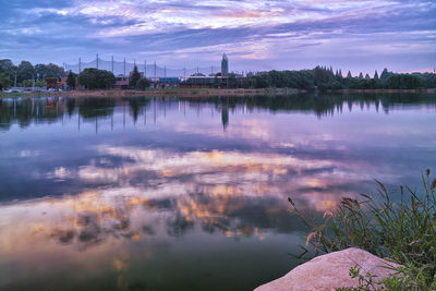 Scenic view of lake against sky at sunset