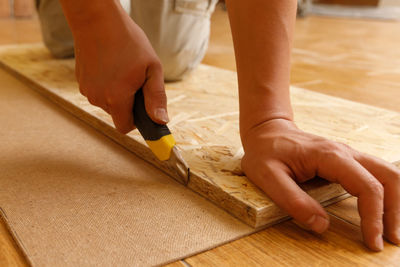 Low section of man working on table