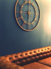 Low angle view of illuminated clock against sky