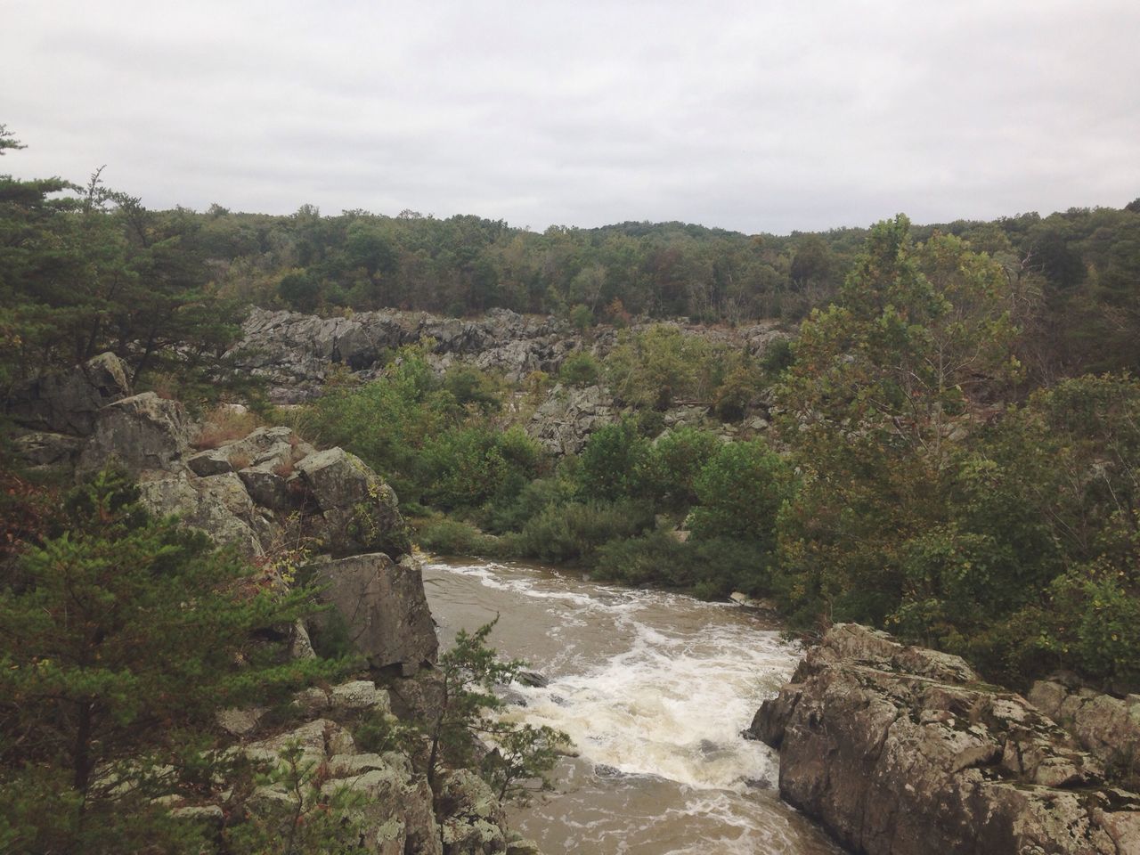 rock - object, rock formation, scenics, beauty in nature, nature, sky, tranquility, tranquil scene, water, mountain, tree, rock, cliff, non-urban scene, waterfall, landscape, stream, flowing water, rocky mountains, geology