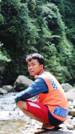 Portrait of boy sitting on land