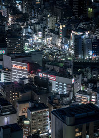 High angle view of illuminated buildings in city at night