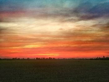 Scenic view of field against sky during sunset