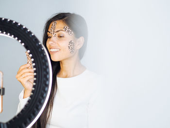 Young pretty beauty blogger with light ring 