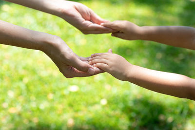 Cropped image of hand touching water