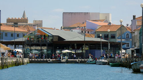 Group of people in city against buildings