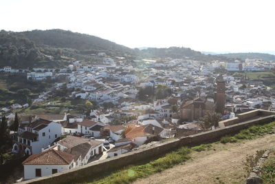 High angle view of houses in town against clear sky