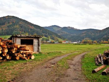 Scenic view of field and houses against sky