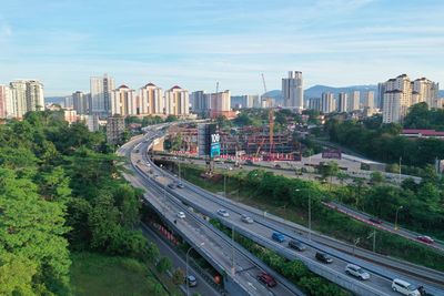 High angle view of street amidst buildings against sky