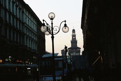 Low angle view of illuminated street light against sky