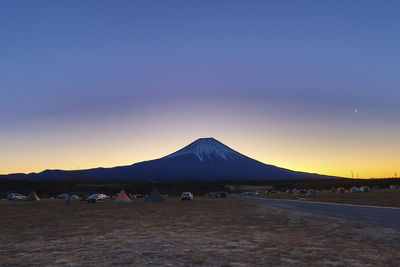 Scenic view of mountains against clear sky during sunset