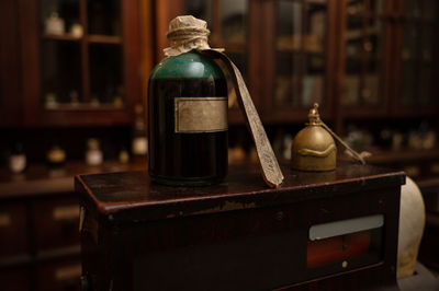 Close-up of bottle on wooden box