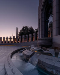 View of buildings against clear sky at dusk