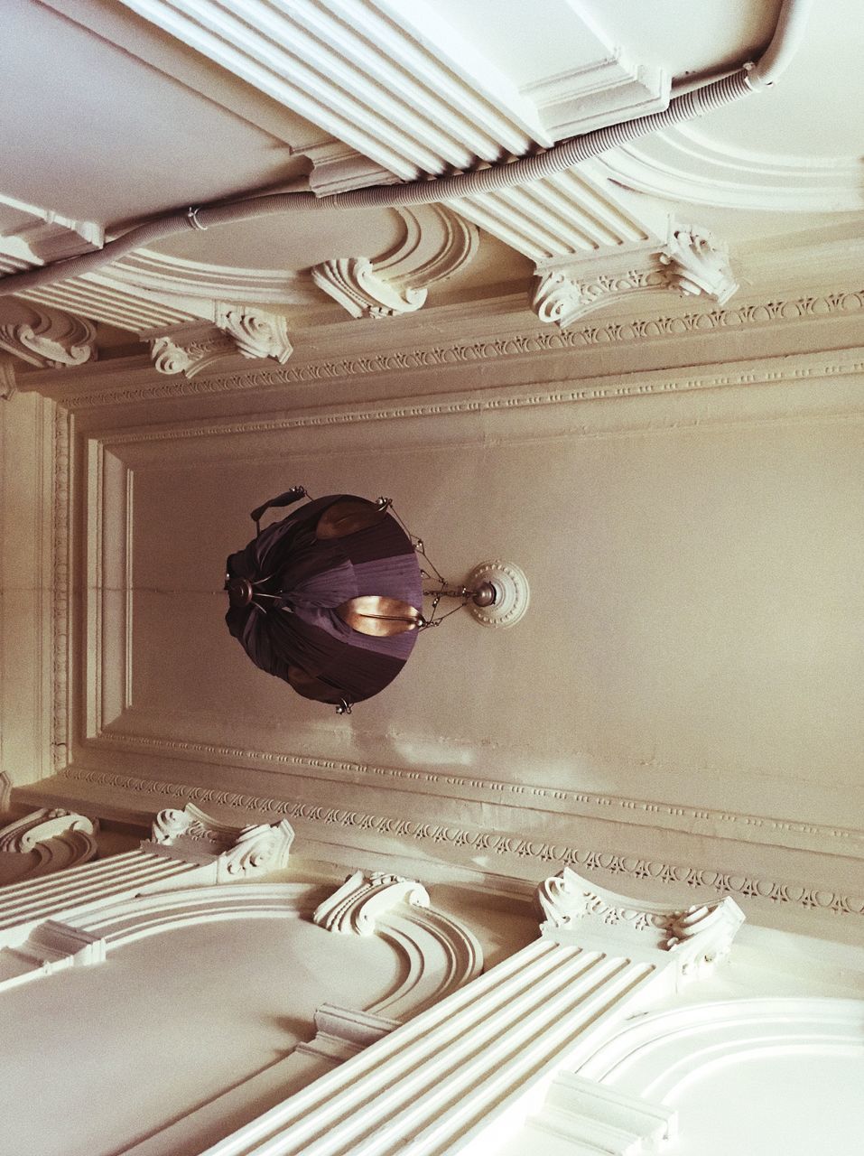 HIGH ANGLE VIEW OF MAN PAINTING ON CEILING OF BUILDING