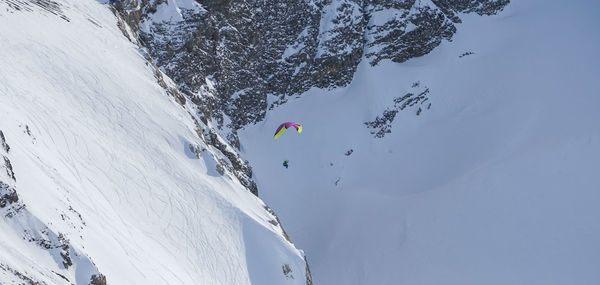 People walking on snow covered mountain