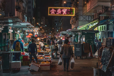 People on street market in city at night