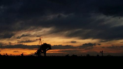 Silhouette of landscape against cloudy sky