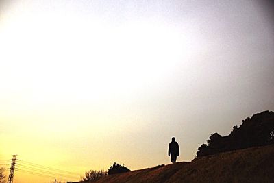 Silhouette of woman at sunset