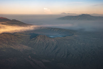 Aerial view of volcanic mountain against sky during sunset