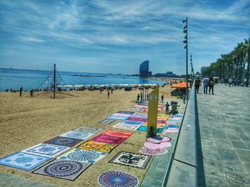 People at beach against sky