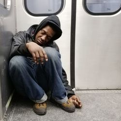 Young man sleeping in car