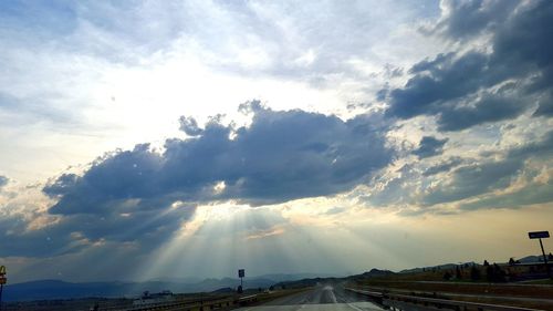 Empty road against cloudy sky