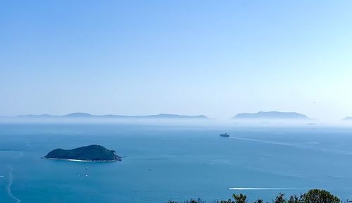 High angle view of sea against clear blue sky