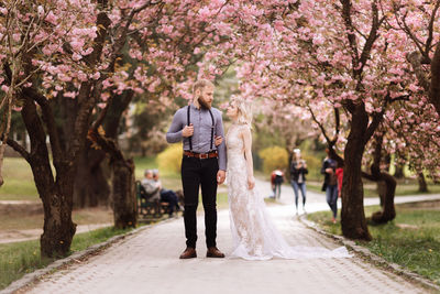 Full length of couple standing on footpath