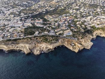 High angle view of sea and buildings in city