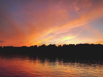 Scenic view of lake against romantic sky at sunset