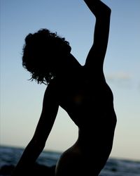 Close-up of silhouette woman against sea