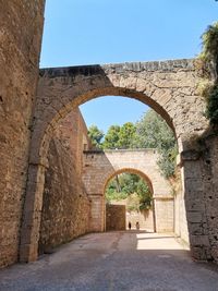 Archway of historic building against sky