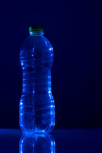 Close-up of glass bottle against black background