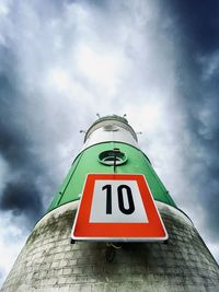 Low angle view of road sign against sky