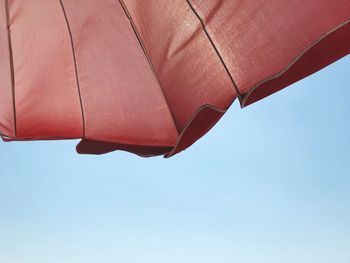 Low angle view of umbrella against sky