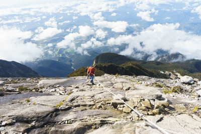 Man standing on mountain against sky