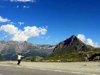 Man standing on mountain against sky