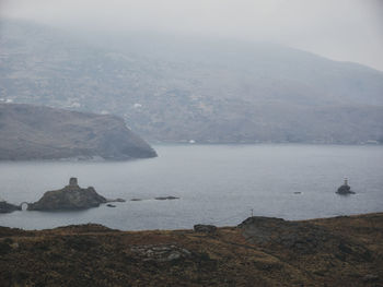 Scenic view of sea and mountains against sky