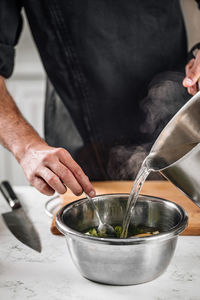 Midsection of man preparing food