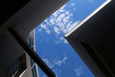 Low angle view of building against cloudy sky