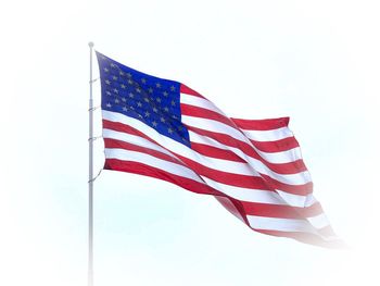 Low angle view of flags flag against sky