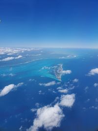 Aerial view of sea against blue sky
