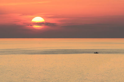 Scenic view of sea against orange sky