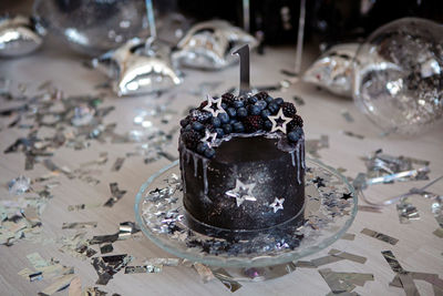 Black cake with stars and berries with the number one