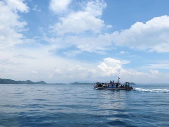 Boat sailing in sea against sky